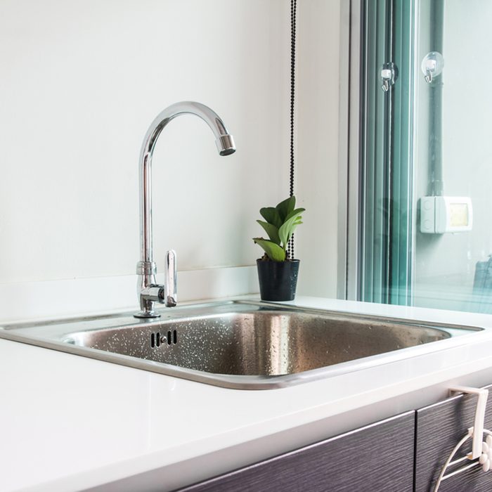 Water tap with sink in modern kitchen.; Shutterstock ID 558969325