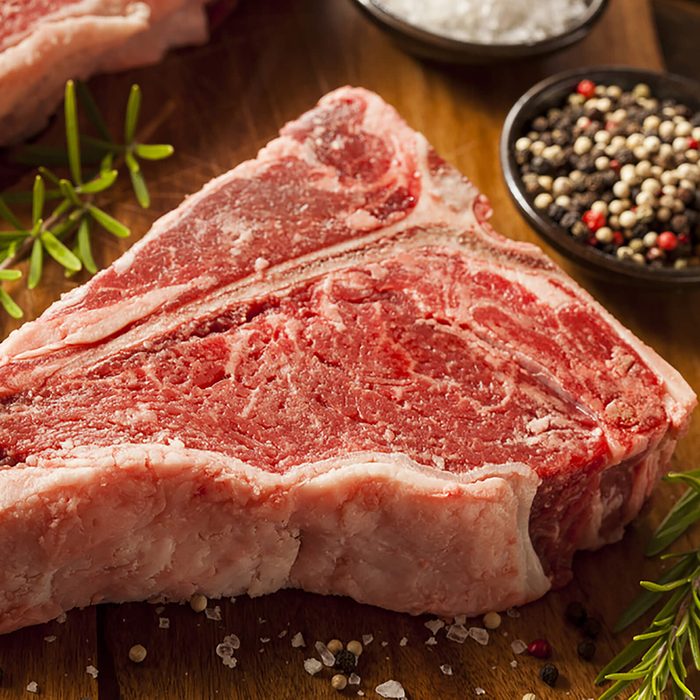 Thick Raw T-Bone Steak with Seasoning and Rosemary; Shutterstock ID 152034248; Job: RD