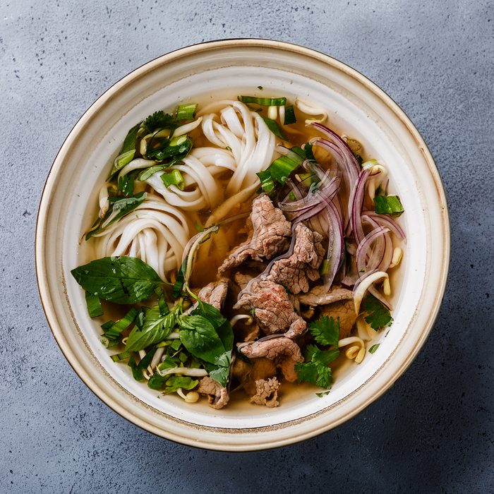 Pho Bo vietnamese Soup with beef in bowl on concrete background