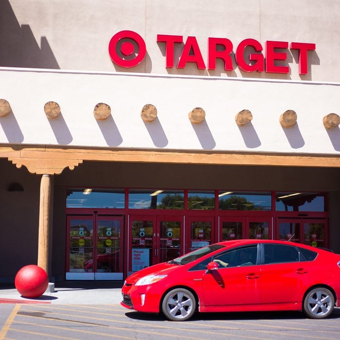 Santa Fe, NM: A red car drives past the entrance to Target, which is constructed in the Southwest Pueblo architectural style.