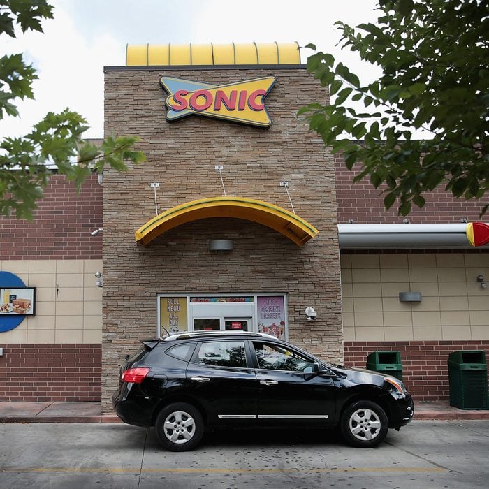 CHICAGO, IL - SEPTEMBER 25: A customer picks up food at the drive-up window at a Sonic restaurant on September 25, 2018 in Chicago, Illinois. Inspire Brands Inc., the parent company of Arby's and Buffalo Wild Wings, announced today that it was buying Sonic for $2.3 billion. (Photo by Scott Olson/Getty Images)