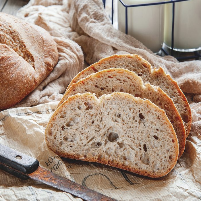 Delicious homemade sourdough rye bread on a plate and milk. Homemade baking.