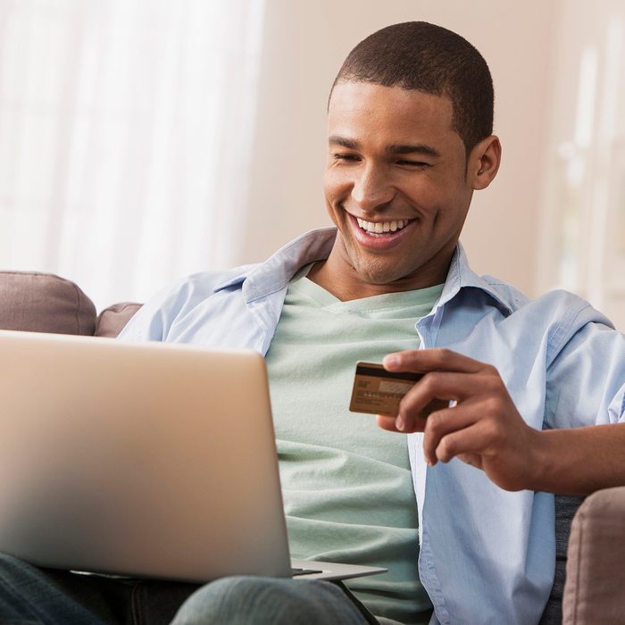 Young adult male making online purchase