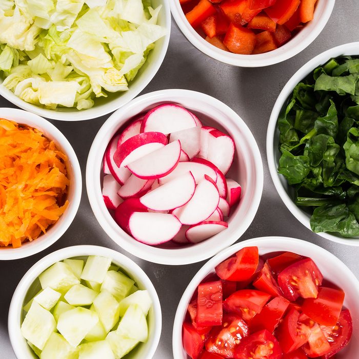 Mix of vegetable bowls for salad or snacks on gray background. Diet detox concept