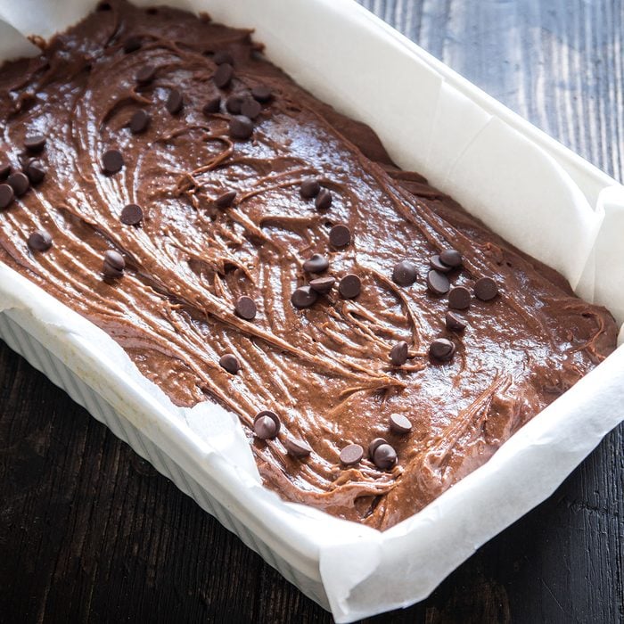 Basic homemade brownie or chocolate cake raw dough in baking pan. Cooking (baking) homemade chocolate cake or brownie.