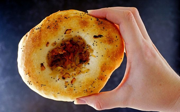freshly baked bialy filled with caramelized onions and poppyseeds