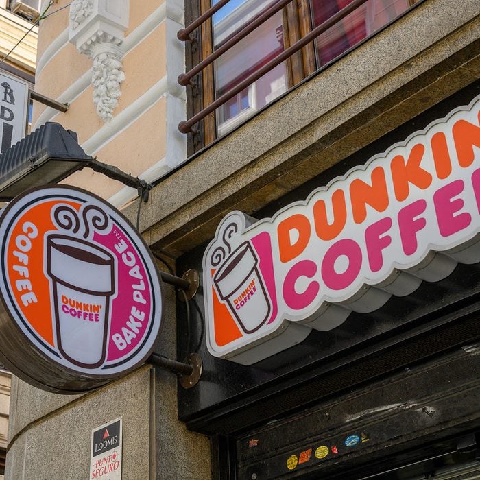MADRID, SPAIN - MAY 04: Street sign outside Dunkin' Coffee shop near Puerta del Sol square on May 04, 2019 in Madrid, Spain. Dunkin', formerly Dunkin' Donuts, is an American multinational coffee company and quick service restaurant. (Photo by Horacio Villalobos - Corbis/Corbis via Getty Images)