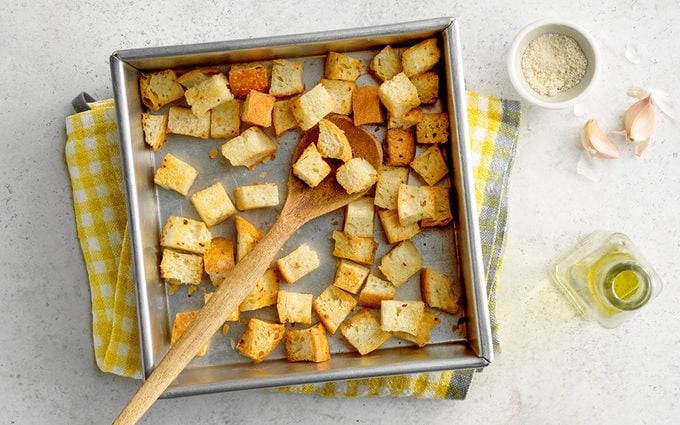 Homemade croutons in pan with ingredients.