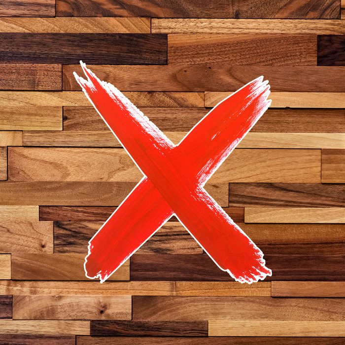 lacquer finish wood surface close-up with a red "x"