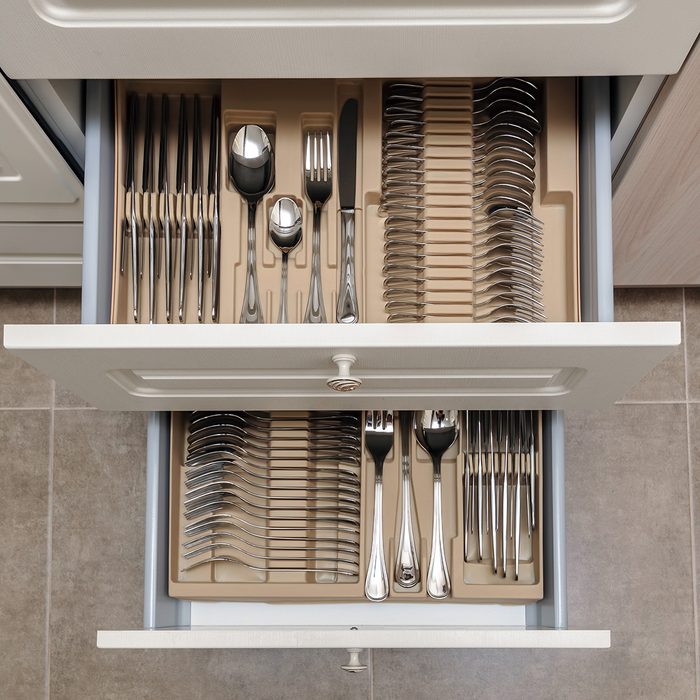 Two open drawers with neatly organized silverware