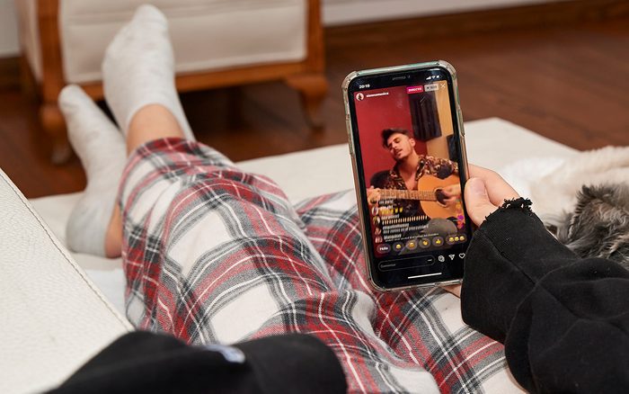 MADRID, SPAIN - MARCH 13: In this photo illustration, A teenager watches Sienna's online concert at her home following the recommendation of staying at home to fight COVID-19 on March 13, 2020 in Madrid, Spain. '#yomequedoencasa' is a streaming music festival promoted by more than 40 Spanish artist to entertain people who has to stay at home due to COVID-19. (Photo Illustration by Carlos Alvarez/Getty Images)