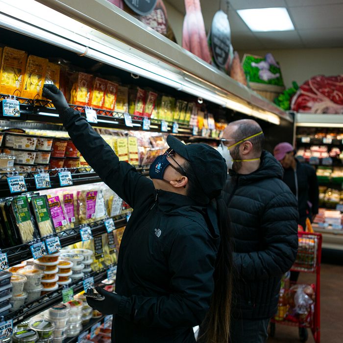 BROOKLYN, NEW YORK - MARCH 28: Shoppers wearing a surgical masks look at a prepared meals at a Trader Joes in Brooklyn, New York on March 28, 2020. The store lets in a minimum amount of shoppers at one time due to the spreading coronavirus. Trader Joes is an American chain of grocery stores headquartered in Monrovia, California. (Photo by Robert Nickelsberg/Getty Images)