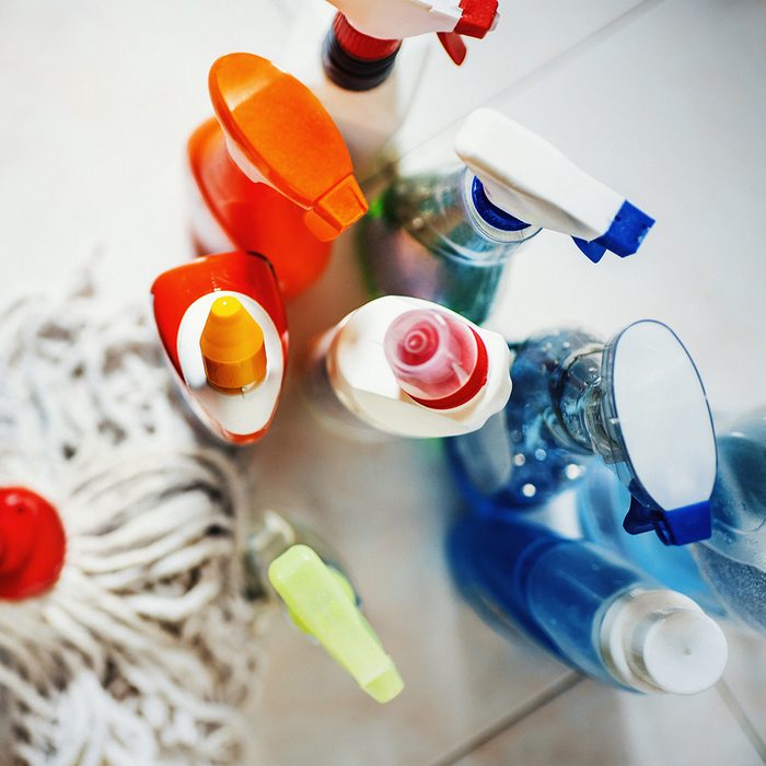 Various spray bottles and a mop