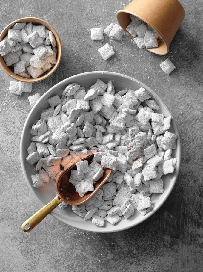 Bowl with Puppy Chow and serving spoon.