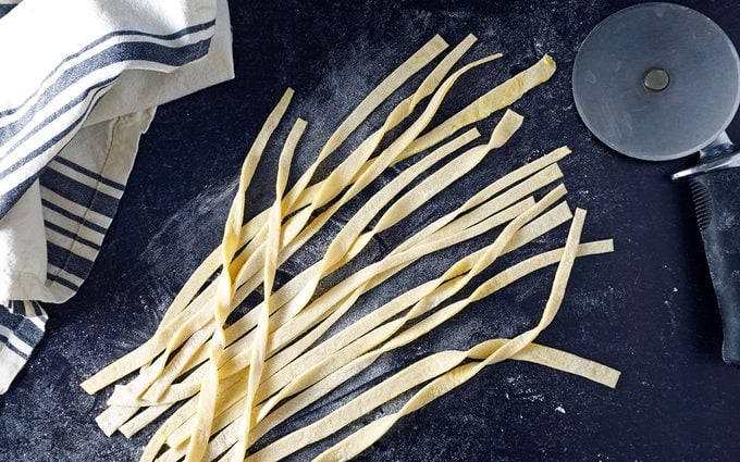 slice egg noodle dough into thin strips