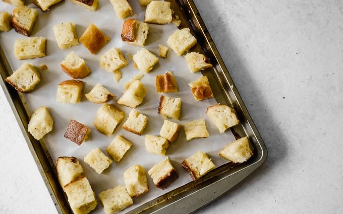 Homemade croutons on pan ready to bake