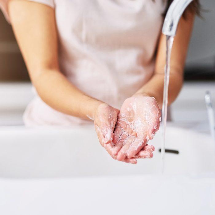 Closeup shot of an unrecognizable woman washing her hands