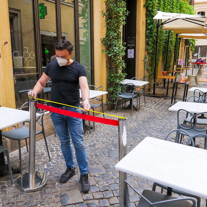 Rome, Italy, May 18 -- The owner of a pizzeria in the historic center of Rome near Piazza Navona measures the distance between the tables to ensure social distancing for the reopening of his restaurant after the end of the two month restrictions imposed by the lockdown for the Covid-19 crisis.