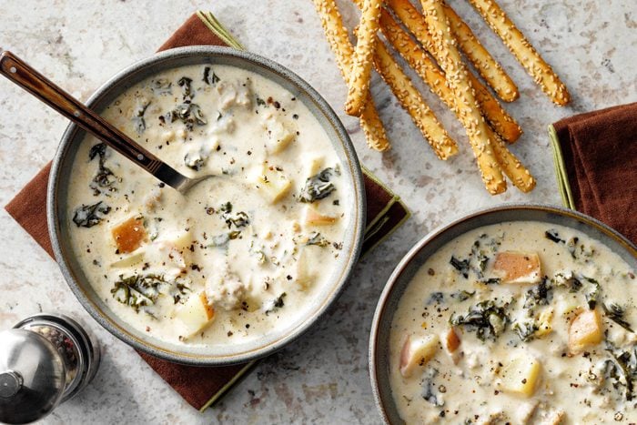 finished bowl of Zuppa Toscana with bread sticks on the side