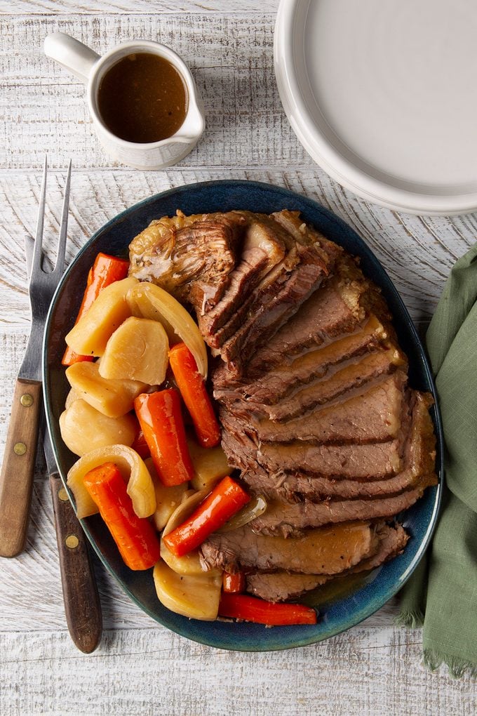 Easy Crockpot pot roast on a platter with gravy.