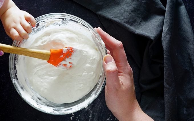 mixing Hostess cupcake filling with toddler