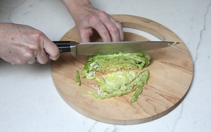 Slicing lettuce into shreds