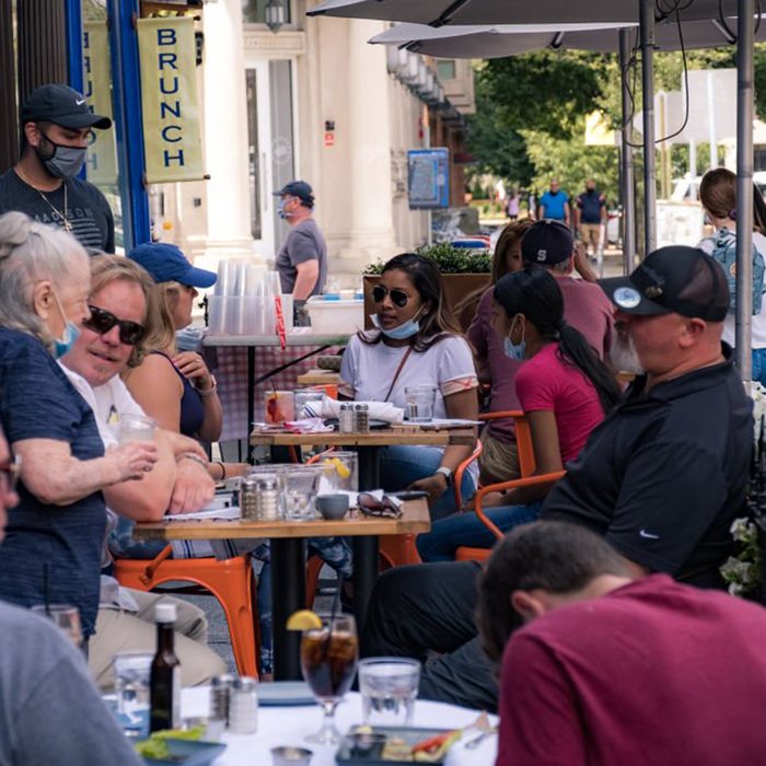 People eating outdoors at a busy restaurant