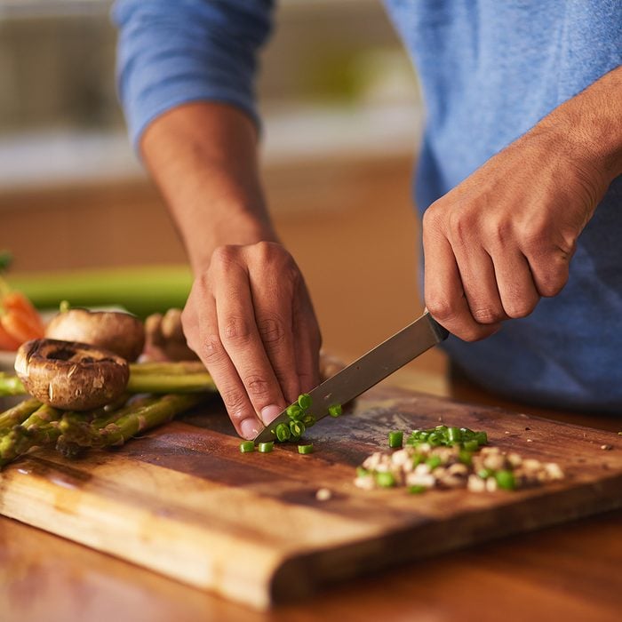Cropped shot of a man preparing a healthy meal at home