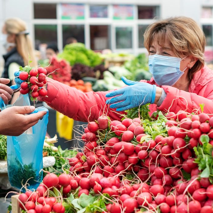 Woman shopping in the farmer's market during COVID-19 crisis.