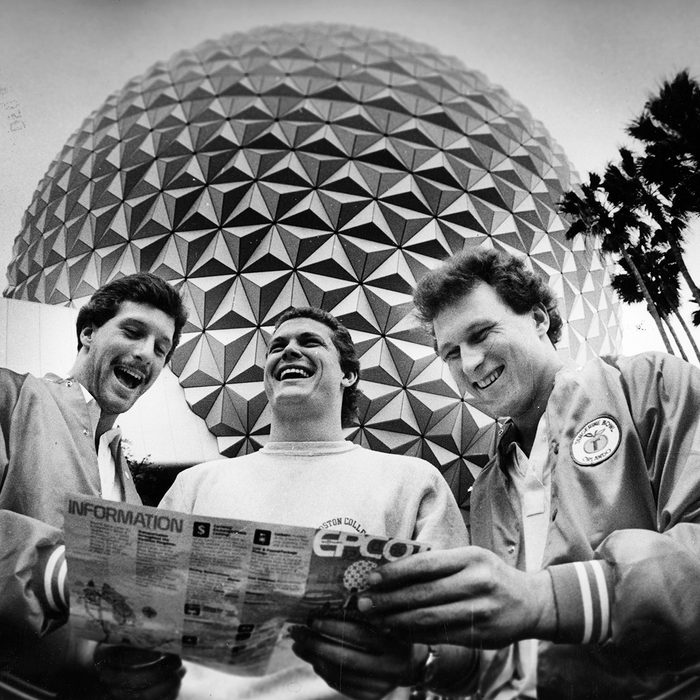 ORLANDO, FL - DECEMBER 1: Standing in front of the "Spaceship Earth" globe at the EPCOT Center at Walt Disney World, Boston College players, form left, Jim Brown, Scott Nizolek and Brian Krystoforski check a map of the attractions while on tour, December 1982. BC was in town to play Auburn in the Tangerine Bowl. (Photo by John Tlumacki/The Boston Globe via Getty Images)