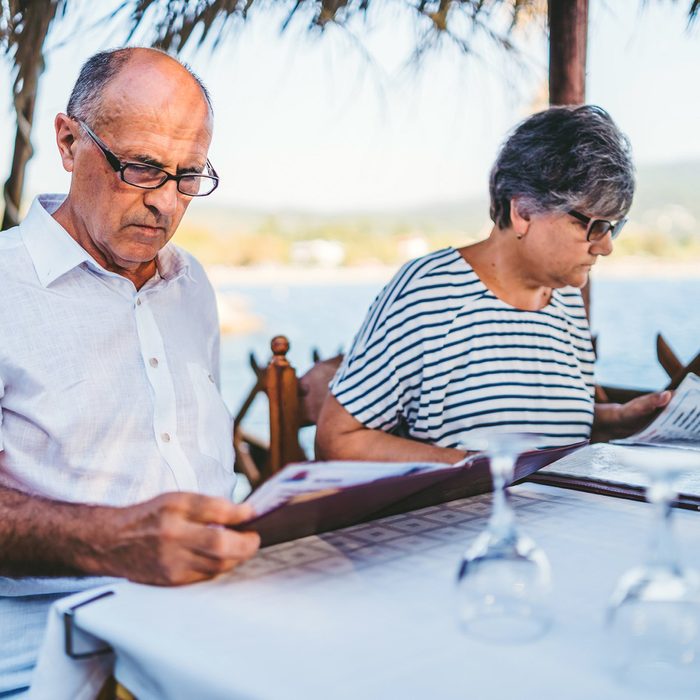 Senior couple reading menus