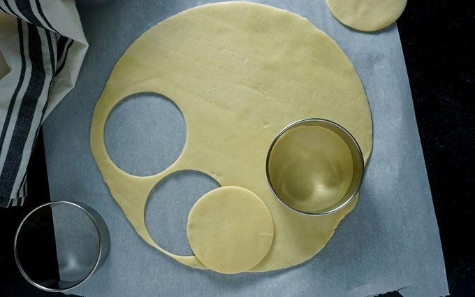 cutting out pie dough for mini pies in canning jar lid