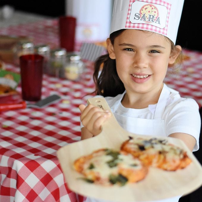 young girl with pizza for Pizza birthday party ideas