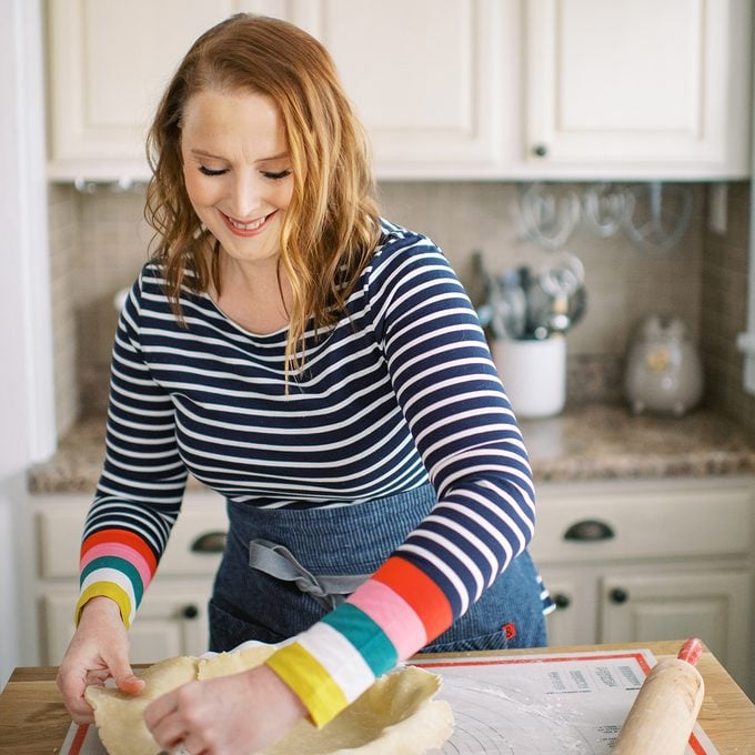 Jennifer trimming pie crust edge