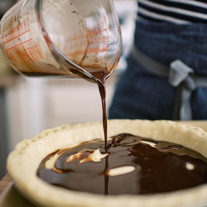 Pouring chocolate into pie crust