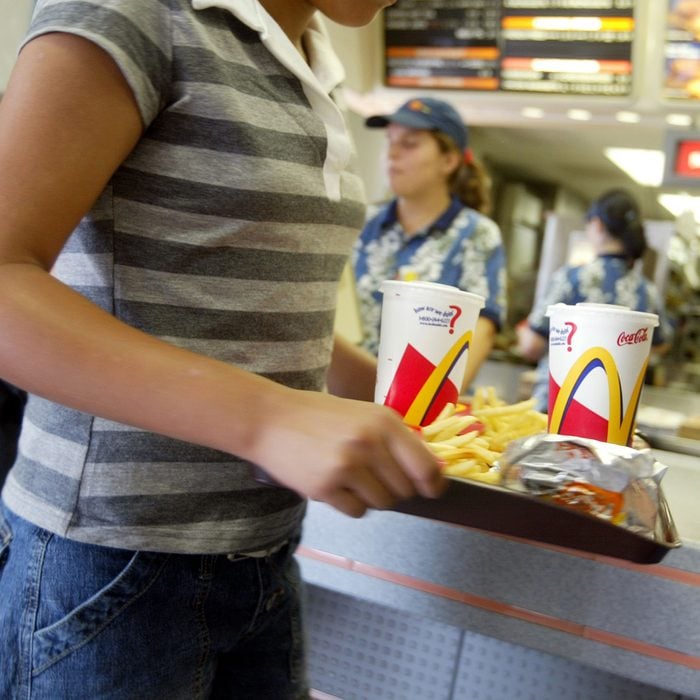 MIAMI, FL - JUNE 19: A customer carries a tray of food at McDonald's June 19, 2003 in Miami, Florida. News reports say that In response to warnings that use of antibiotics on U.S. farms is making the drugs less effective for treating people, the fast-food chain is directing some meat suppliers to stop using antibiotic growth promoters altogether and encouraging others to cut back. (Photo by Joe Raedle/Getty Images)
