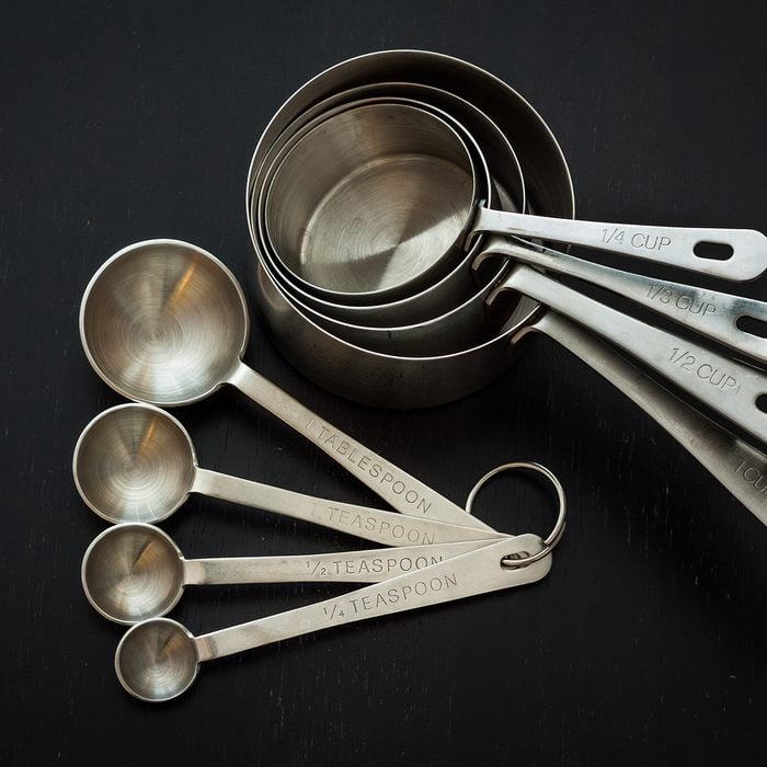 Measuring cups and spoons with a dark background.