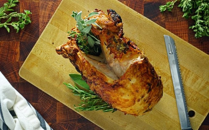 finished air fryer turkey breast resting on a carving board