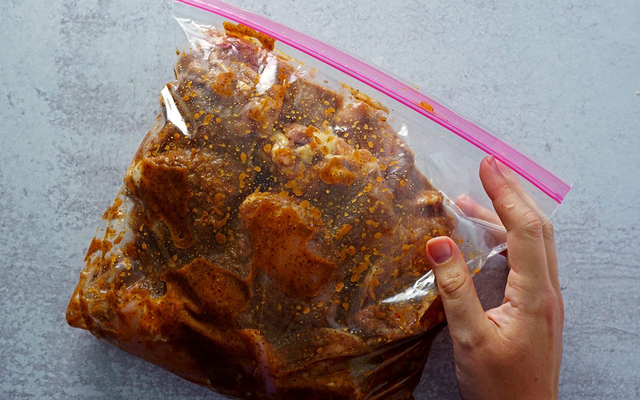 chicken thighs in a bag coated in chipotle-style marinade