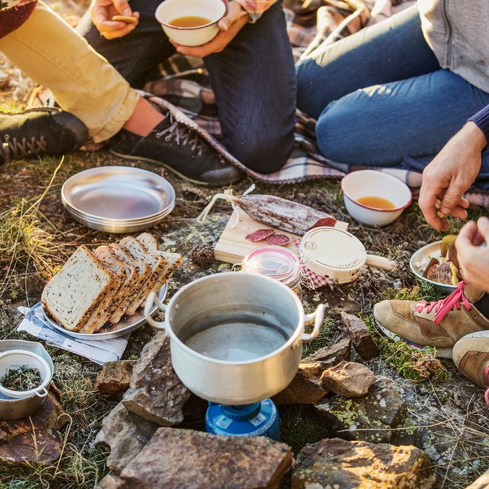 Friends preparing breakfast at campsite
