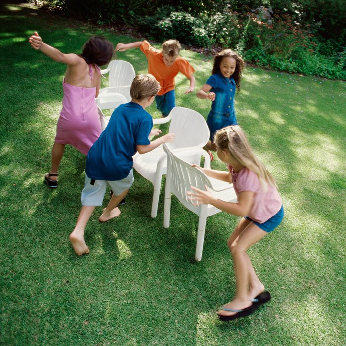 Children Playing Musical Chairs in Back Yard