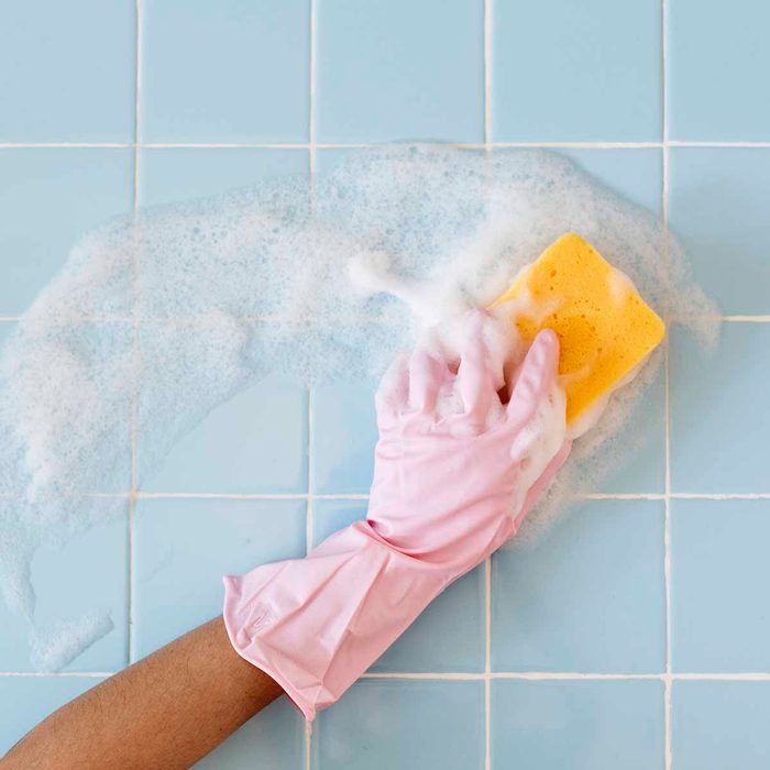 scrubbing tile with a sponge