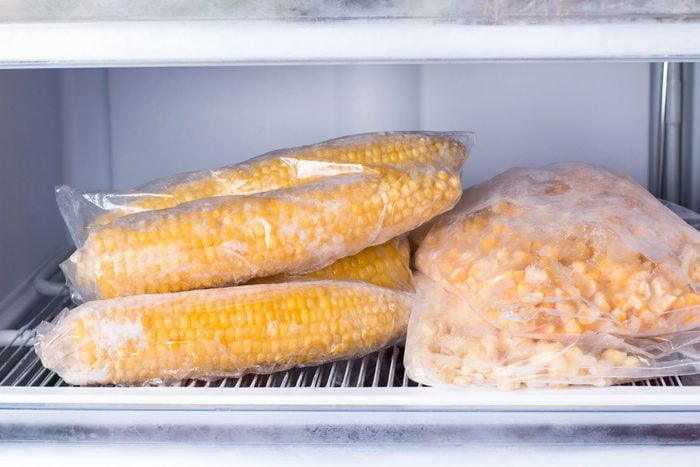 Frozen corn in bag in freezer close up