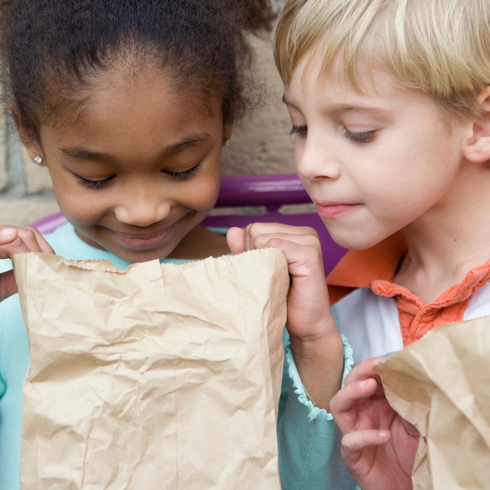 birthday party games for kids Boy Looking In Friends Lunch Bag At Recess