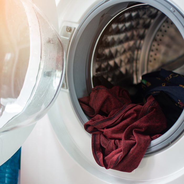 open washing machine and take of cloth out when finish cleaning. soft focus.