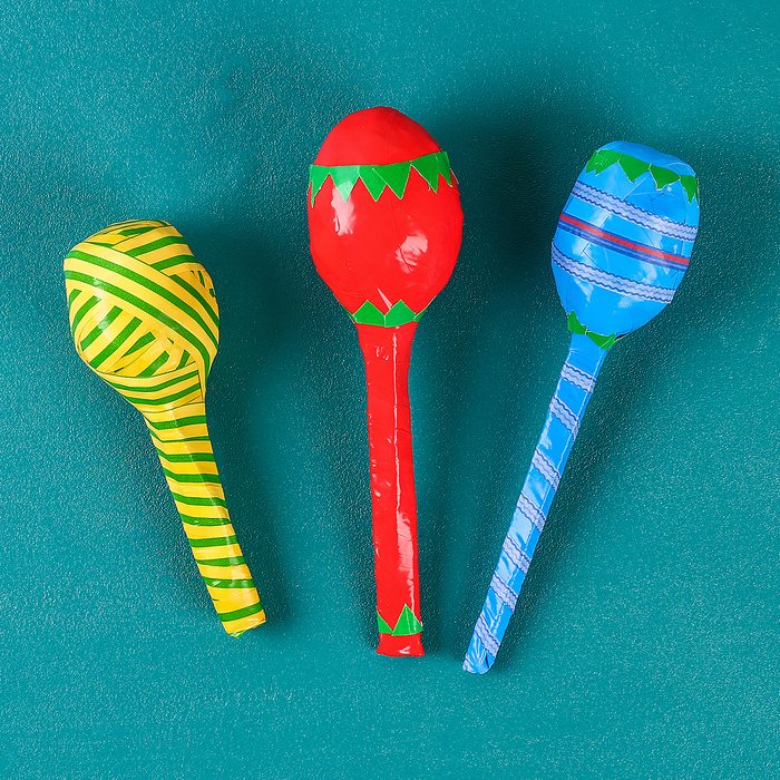 Diy cinco de mayo maracas from eggs, spoons and cereals on a green background. Gift idea, decor cinco de mayo. Step by step. Top view. Process kid children craft.