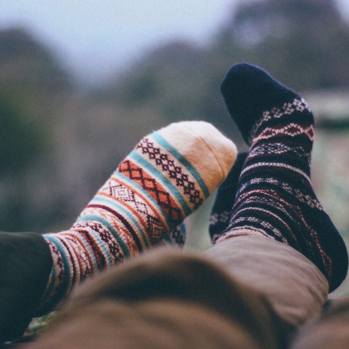 Low Section Of People Wearing Socks Against Defocused Background