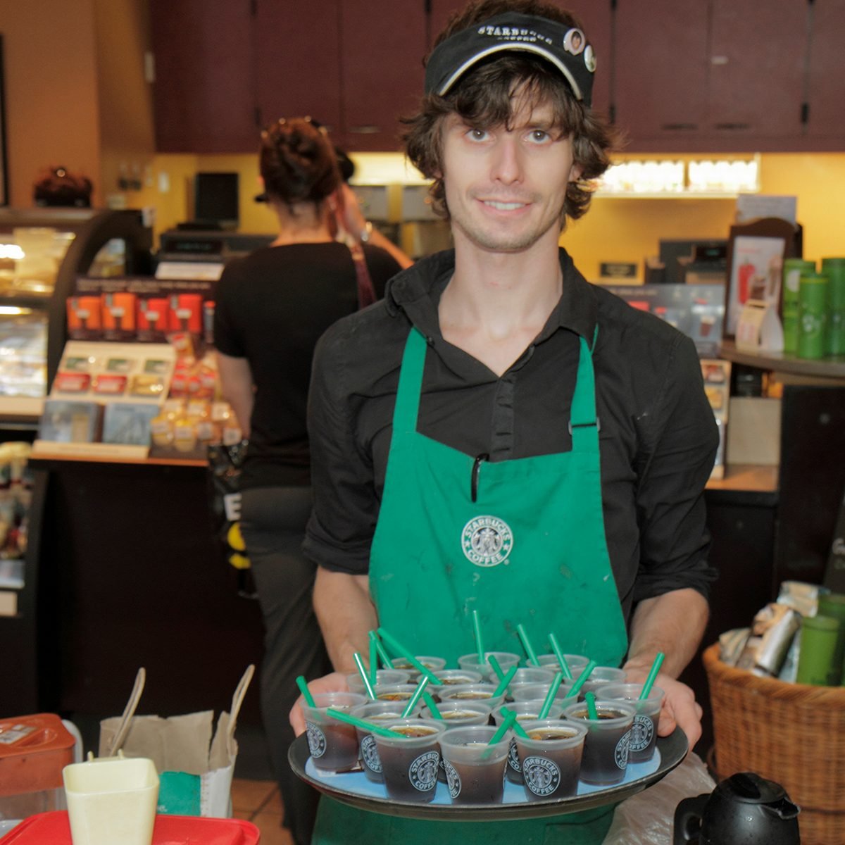 A man offering free samples at Starbucks on Market Street. (Photo by: Jeffrey Greenberg/Universal Images Group via Getty Images)