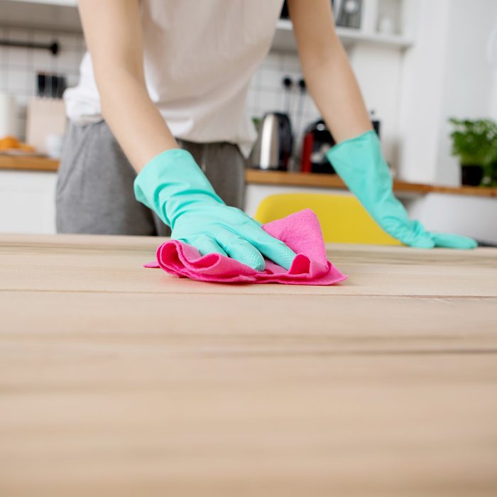 Young woman is cleaning the kitchen in home.