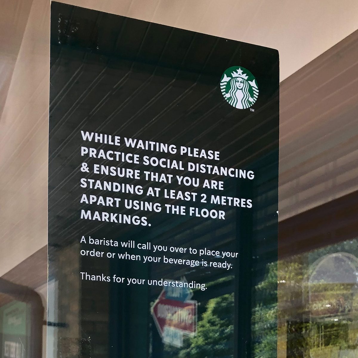 SOUTHAMPTON, ENGLAND - MAY 15: (EDITORS NOTE - This image was taken on a mobile phone) A sign encouraging social distancing is seen on a window of Starbucks in Hedge End as it re-opens on May 15, 2020 in Southampton, England. The prime minister announced the general contours of a phased exit from the current lockdown, adopted nearly two months ago in an effort curb the spread of Covid-19. (Photo by Naomi Baker/Getty Images)